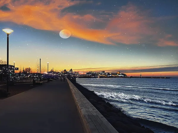 moon on  starry sky in harbor ,blurred city light at night ,pink sunset at  sea ,ship on horizon seafront people walk  promenade boulevard,cloudy evening sky at summer , nature landscape background, horizon,ocean water waves, Tallinn Estonia ,Baltic