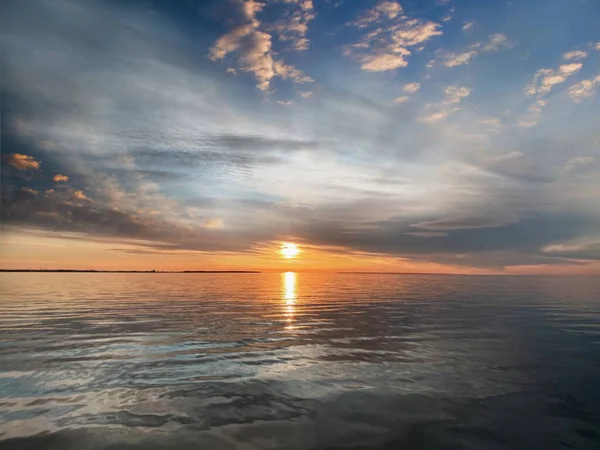 sunset at sea pink blue gold yellow colorful sun light reflection at sea water wave seashell  clouds on  beautiful sky sunlight nature background