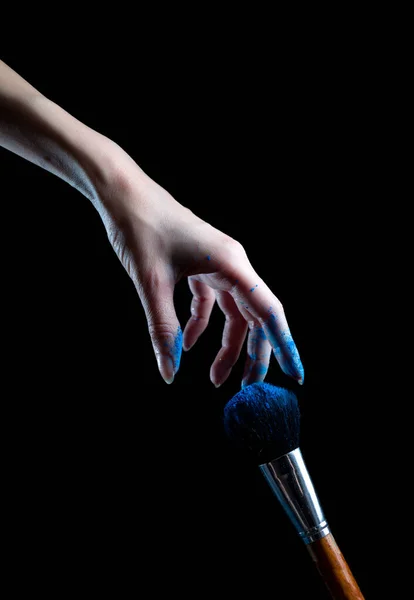 hand and brush for makeup in powder in the paint is very beautiful