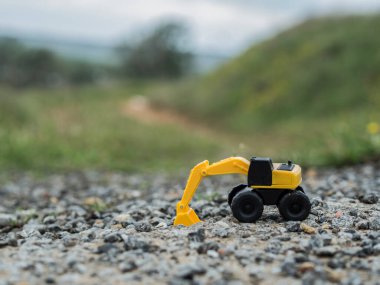 Oyuncak inşaat makineleri bir kazı üzerinde çalışıyor