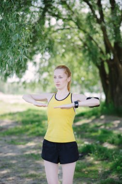 Daha önce çalışma egzersiz yaparak genç fitness kadın.