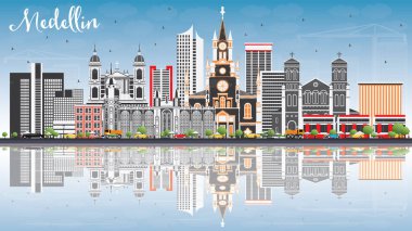 Medellin manzarası ile gri binalar, mavi gökyüzü ve yansımaları.