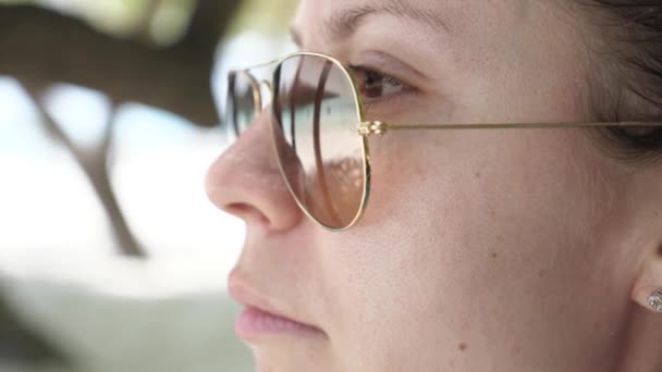 Slow Motion Girl Adjusts Frame Glasses Looking Sea Palm Trees — Stock Video