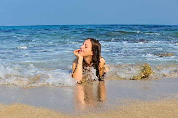 Chica acostada en las olas del mar — Foto de Stock