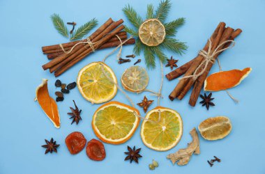 Ingredients for mulled wine. Cinnamon sticks, dry rings of orange and lemon, peel of an orange, anise stars, ginger, cardamom, cloves, raisins. Christmas composition. Concept of Christmas and New year