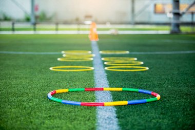 Halka merdiven işareti yeşil artifi üzerinde futbol antrenman ekipmanı.