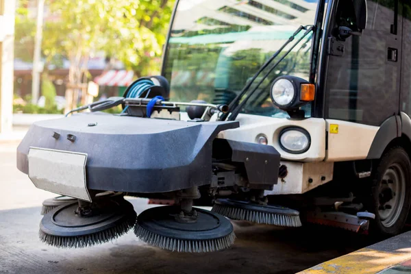 The special car cleans city road. Detail of a street sweeper mac