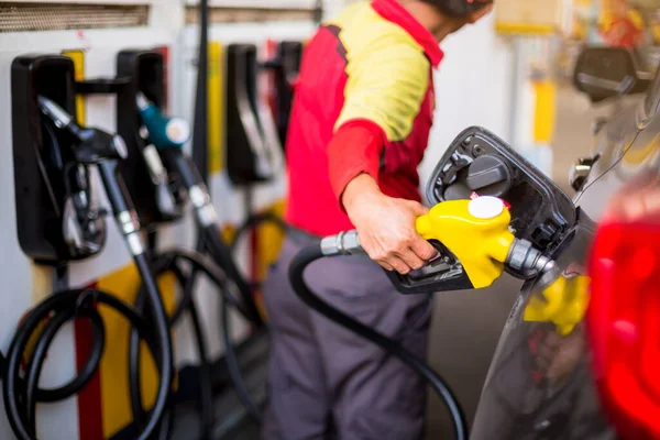 Gelbe Öldüse in der Tankstelle. Hände füllen das Auto mit f — Stockfoto