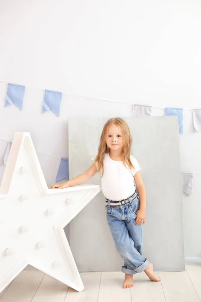 Little Girl Jeans White Shirt Stands Luminous Star Lamp Large — Stock Photo, Image