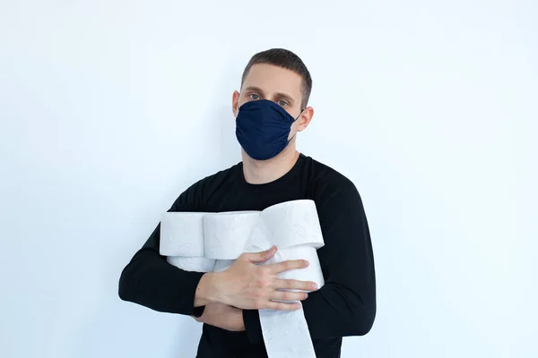 Man storing tissue toilet paper during Covid-19, Concept quarantine. People are stocking up toilet paper for home quarantine from coronavirus. Man with many rolls of toilet paper. people panic.