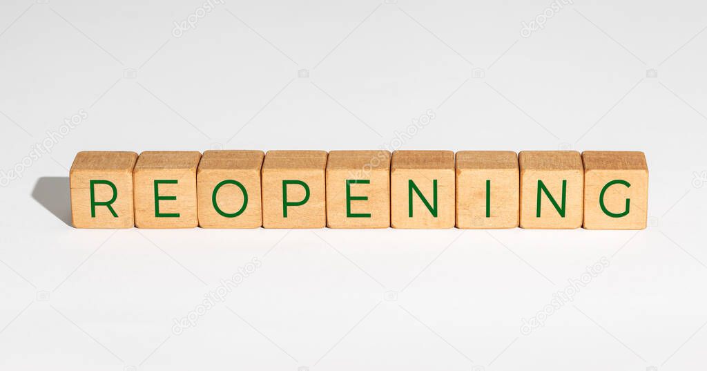 Reopening concept after the coronavirus pandemic. Wooden blocks with text isolated on white background