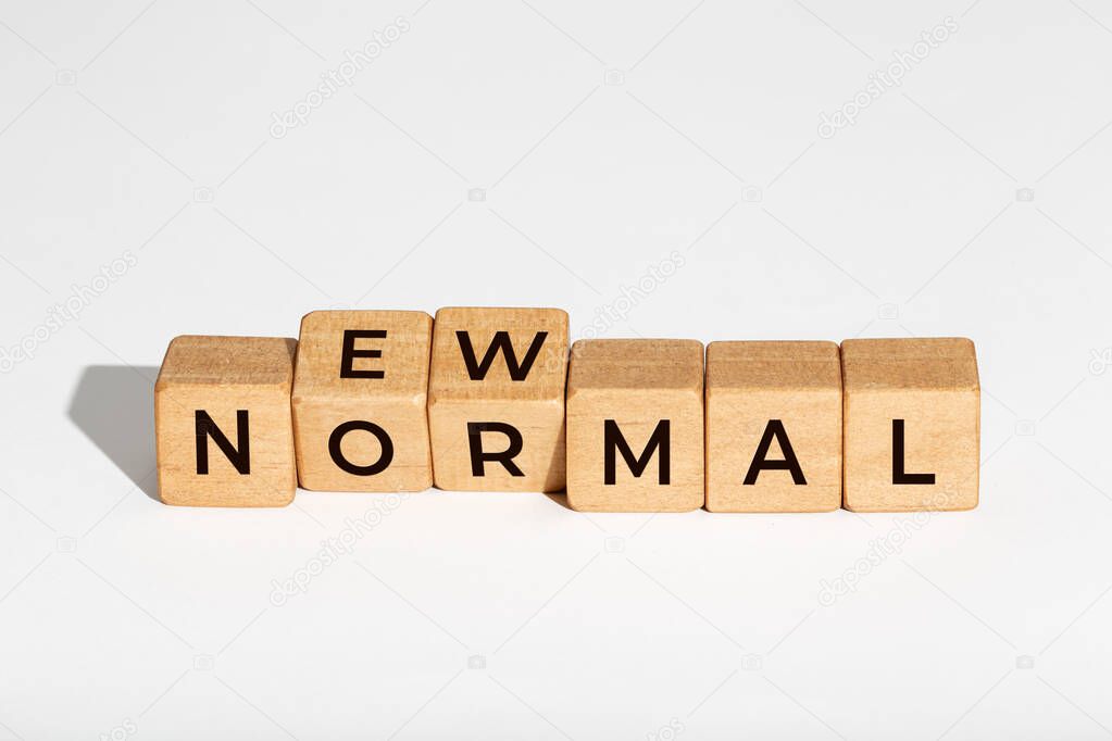 New Normal concept. Wooden dices with text isolated on white background. Copy space