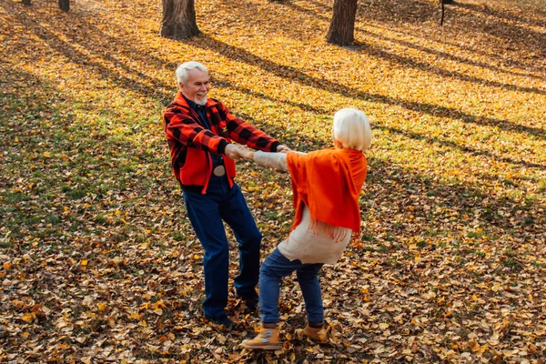 An elderly couple is dancing. Smiling old woman. Movement is life. I feel young again.