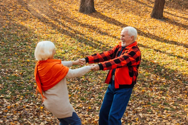 An elderly couple is dancing. Smiling old woman. Movement is life. I feel young again.