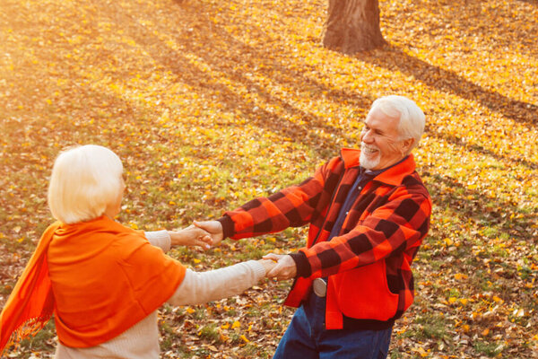 An elderly couple is dancing. Smiling old woman. Movement is life. I feel young again.