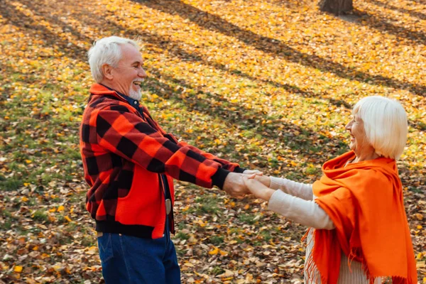 An elderly couple is dancing. Smiling old woman. Movement is life. I feel young again.