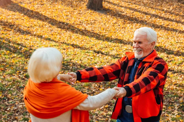 An elderly couple is dancing. Smiling old woman. Movement is life. I feel young again.