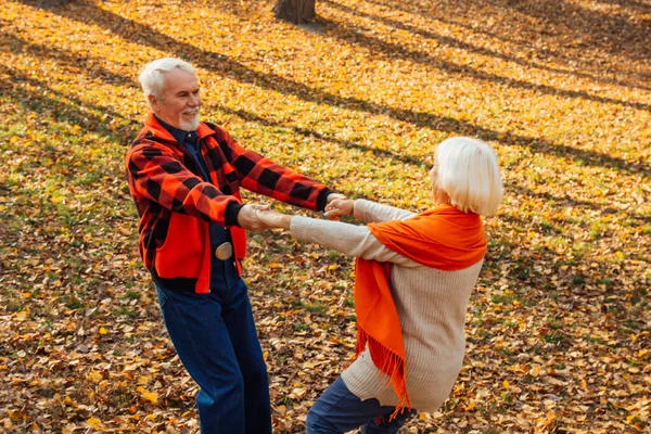 An elderly couple is dancing. Smiling old woman. Movement is life. I feel young again.