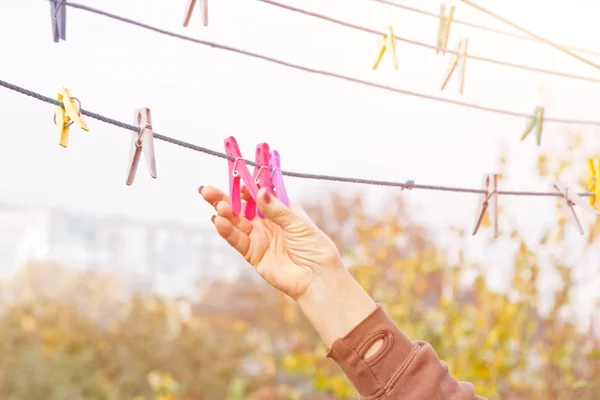 Wasserij vrouw hangt schone natte doek op wasdroger na het wassen thuis. Huishoudelijke taken en huishouding. — Stockfoto