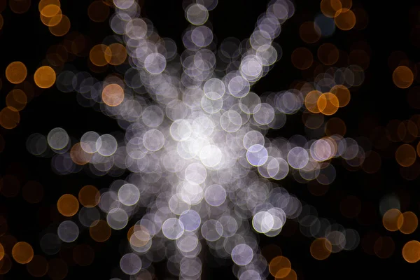 Golden abstract yellow, orange bokeh lights isolated on black background with copy space. Holiday and Christmas season concept, graphic resources, greeting card. wallpaper. Multi-colored lights. — Stock Photo, Image