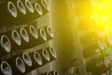 Şarap şişelerinin dibi açık havada raflarda sergileniyor. Yaratıcı karanlık ve soyut bir arkaplan. Alkol kavramı.