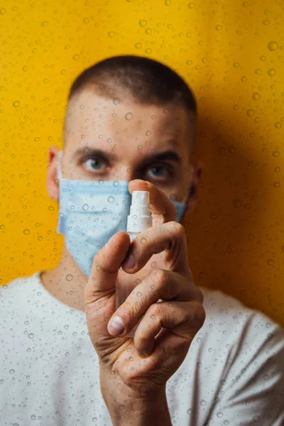 Portrait Young Guy Mask Yellow Background Disinfects Hands Antiseptic Sprays — Stock Photo, Image