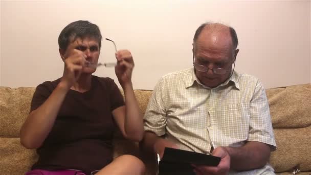 Elderly Couple Sits Sofa Home Try Glasses Vision Consulting Each — Stock Video