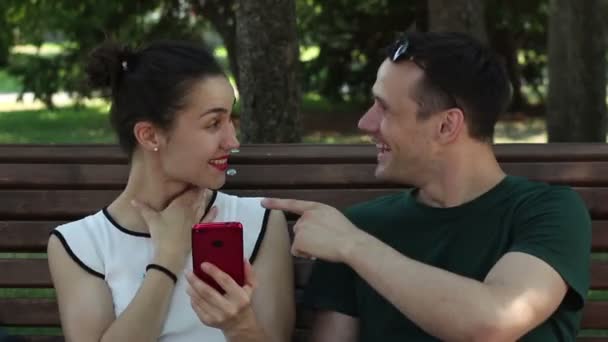 Young Couple Lovers Talking Laughing While Sitting Bench Shade Trees — Stock Video
