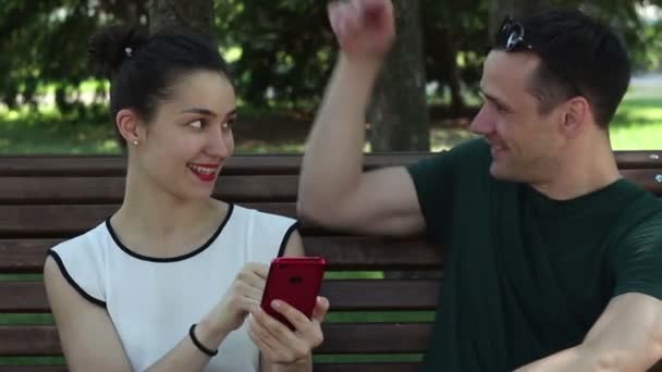 Young Loving Couple Sunny Day Actively Discussing New Smartphone While — Stock Video