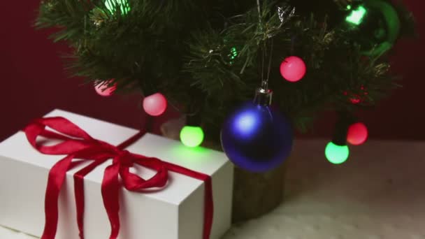 Man Hand Puts Small Gift Blue Box Christmas Tree Gift — Stock Video