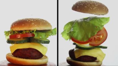 Sığır pirzolası, taze sebze ve krem peynirli büyük sulu burger. Büyük bir hamburgerin bileşimi, malzemeler havada asılı..