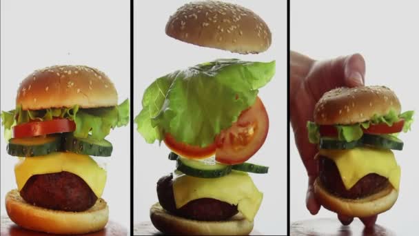 Large juicy burger with beef cutlet, fresh vegetables and cream cheese.Hand of a young guy holds a burger. Composition of a large burger, ingredients individually hang in the air. Multi Screen montage — Stock Video