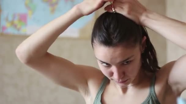 Young Attractive Girl Fixes Her Hair While Sitting Home Early — Stock Video