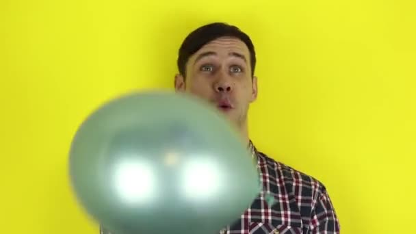Funny Cute Guy Actively Plays Purple Balloon Blows Party Horn — Stock Video
