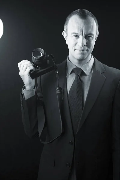 Photographer in studio in suit