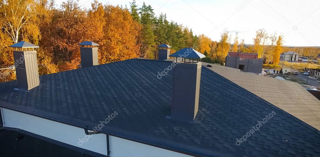 Bituminous tile for a roof. House with a roof from a bituminous tile. a roof from a bituminous tile. Moder