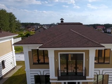 Çatı için küçük fayanslar. Bituminous 'un çatısına sahip bir ev