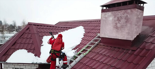 Worker does the installation of the roof of house. Installation