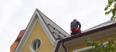 Worker does the installation of the roof of house. Installation clipart