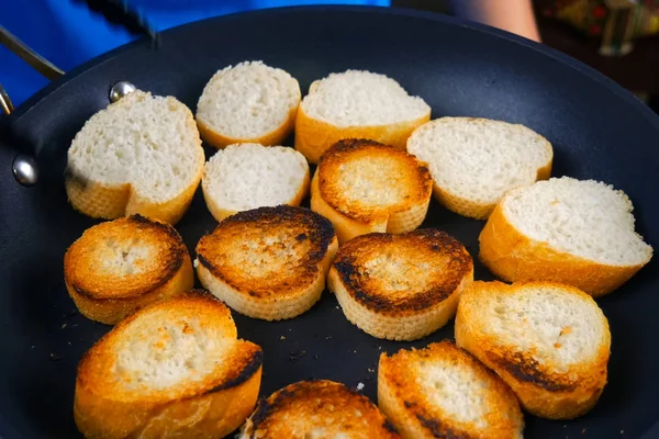 Frying slices of bread in a pan. Toasting bread for sandwich. — Stock Photo, Image