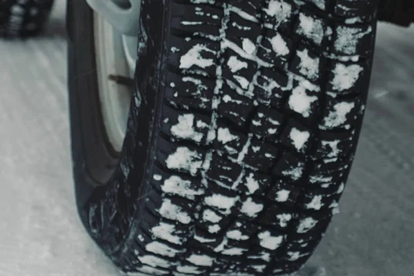 Winter tire car wheels with snow.