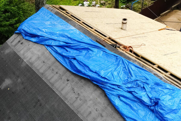 Worker does the installation of the roof of house. Installation