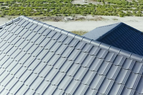 House with a gray metal roof. Corrugated metal roof and metal ro