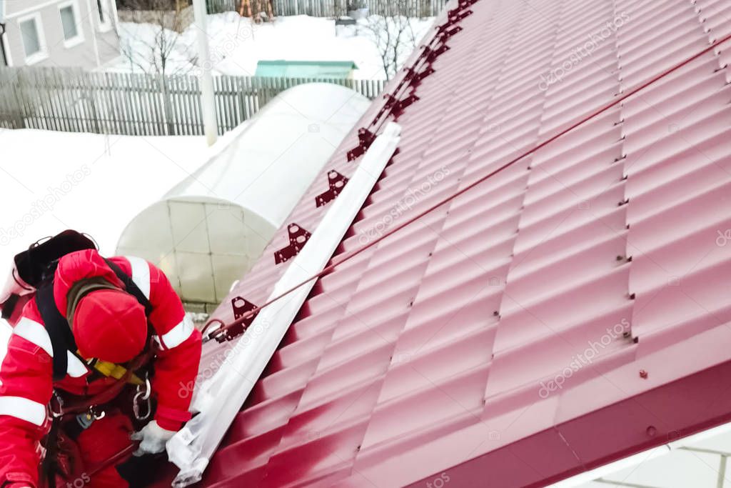 Worker does the installation of the roof of house. Installation