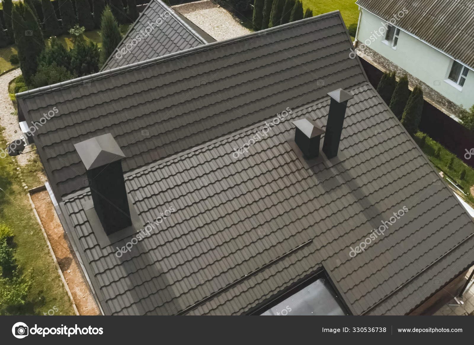 House with a brown metal roof.Corrugated metal roof and metal ro Stock