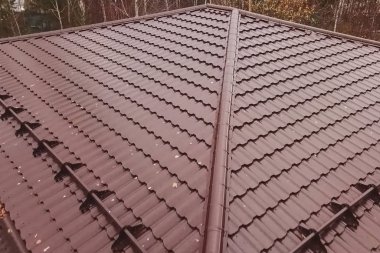 Kahverengi metal çatılı bir ev. Çatı ve metal kaplama.