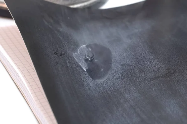 Liquid nitrogen on notebook paper.