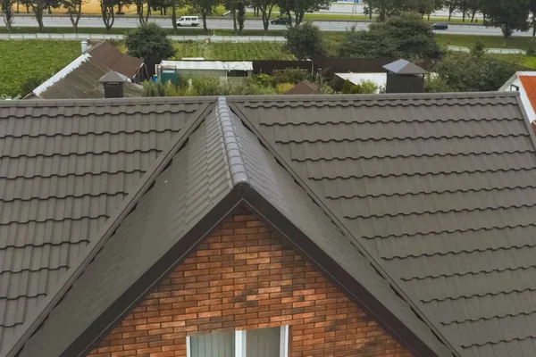 带有棕色金属屋顶的房子。波纹金属屋顶和金属管 — 图库照片