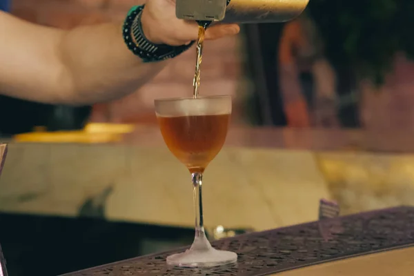 Bartender pouring cocktail at bar counter — Stock Photo, Image