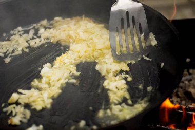 Tavada yağ ile kavrulmuş soğan ateşe.